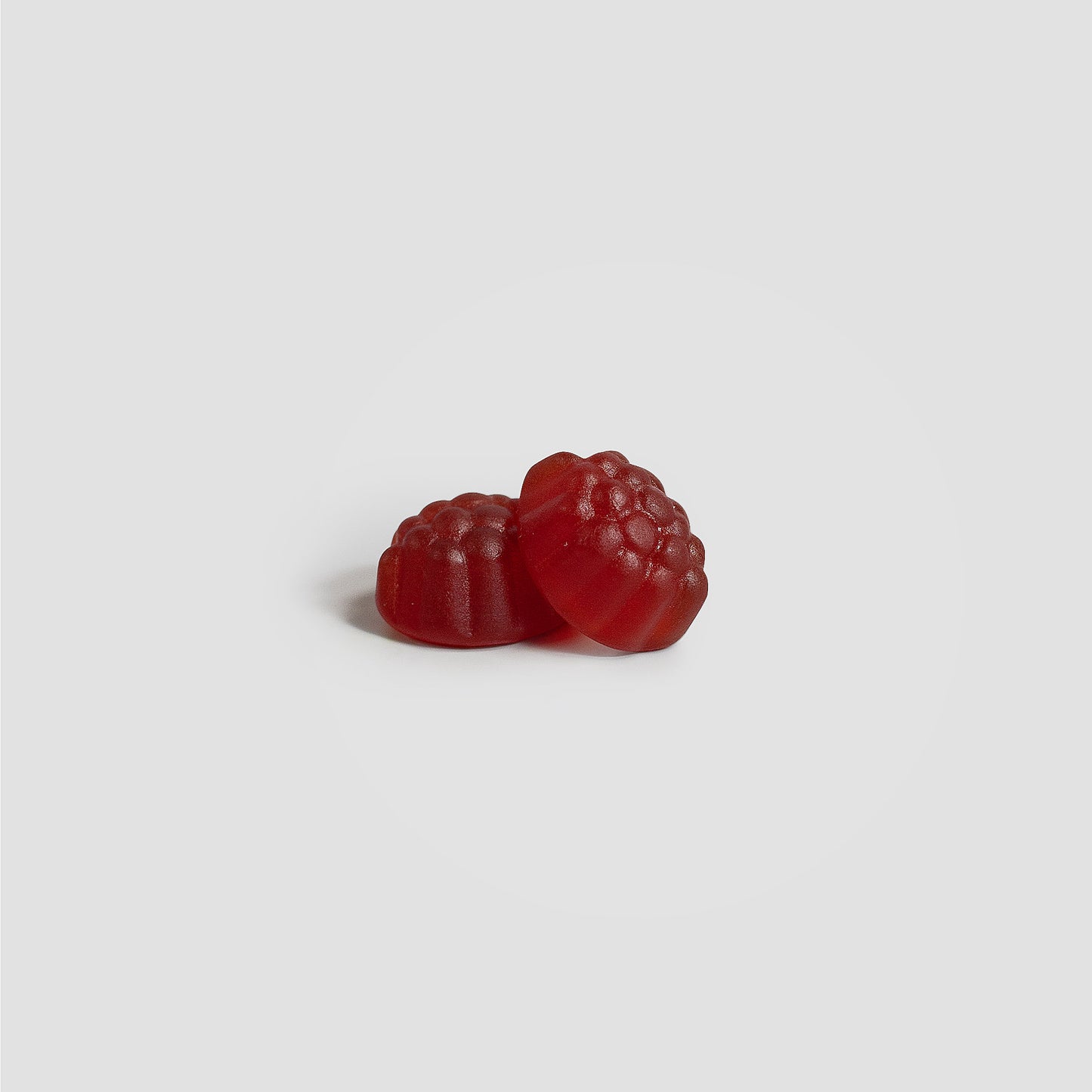 Two red gummy candies on a white background. Support joint health and mobility, fortified with glucosamine, chondroitin, and essential vitamins.