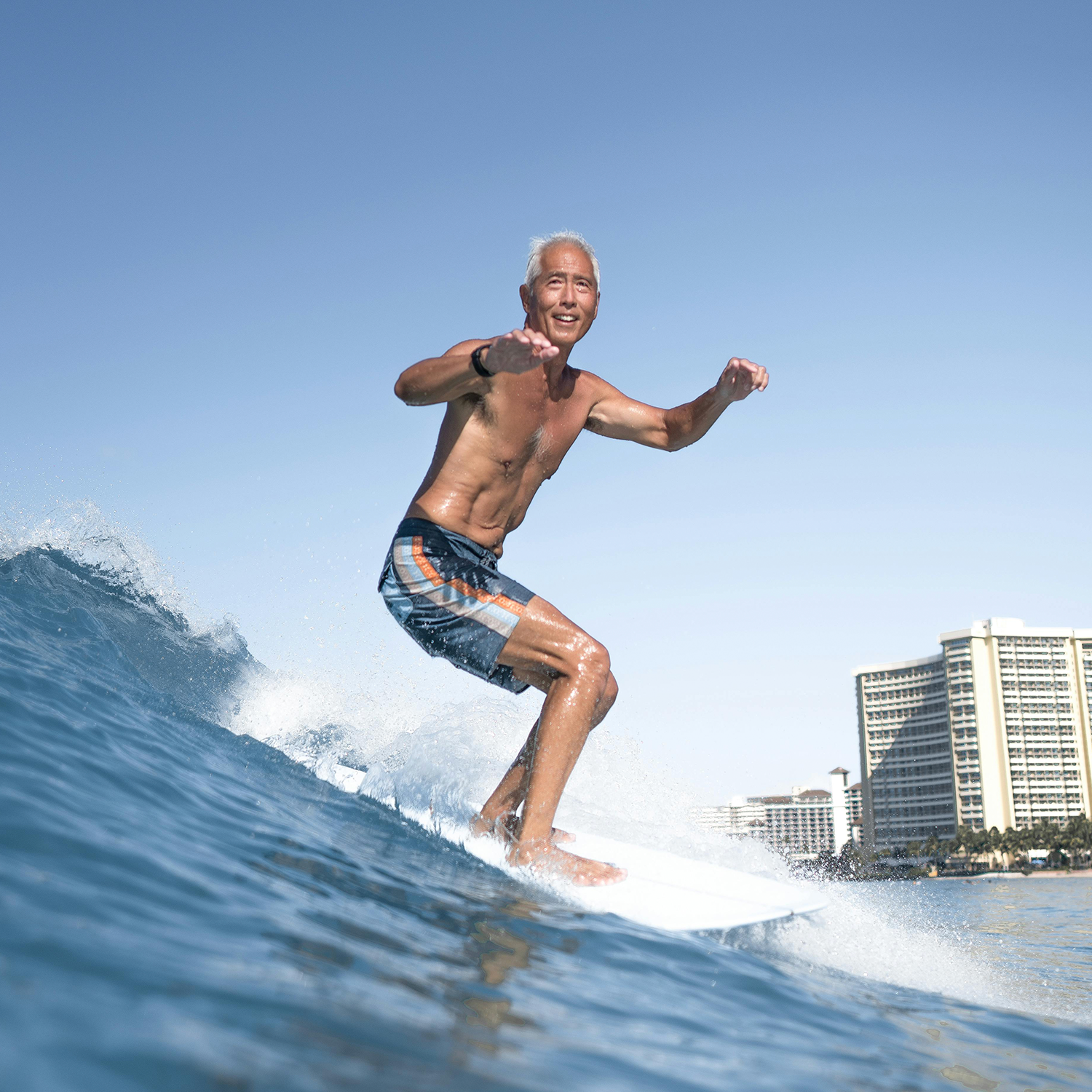 Man surfing a wave on a surfboard.